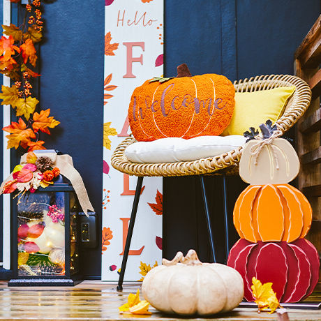 Variety of pumpkin decor placed on a porch.