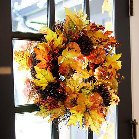 A fall-esq wreath hung on a door.