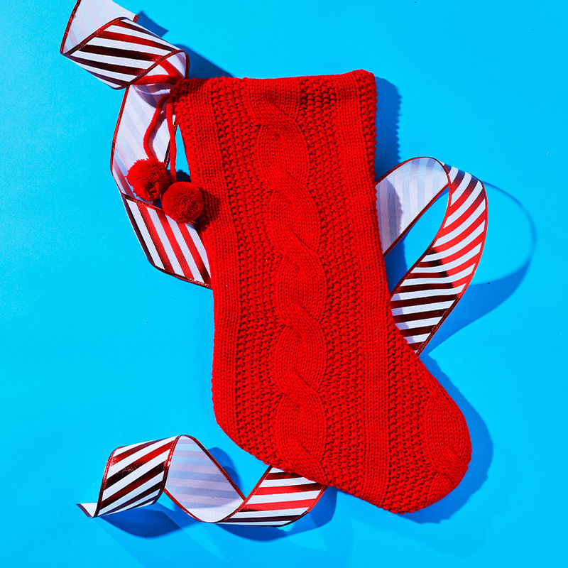 A Christmas Stocking Hung over a fireplace.