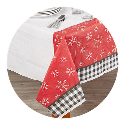 Festive holiday tablecloth with red and green stripes with a snowflake pattern.