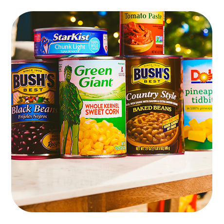 A variety of canned foods from brands such as Green Giant, Bush, Dole, and StarKist