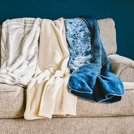 Luxury Plush and Velvet Throw laid across a couch.