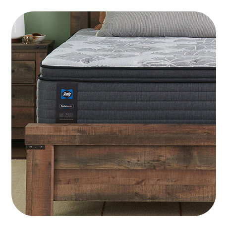 Luxury Sealy and Serta Mattress on top of a Wooden Bed Frame.