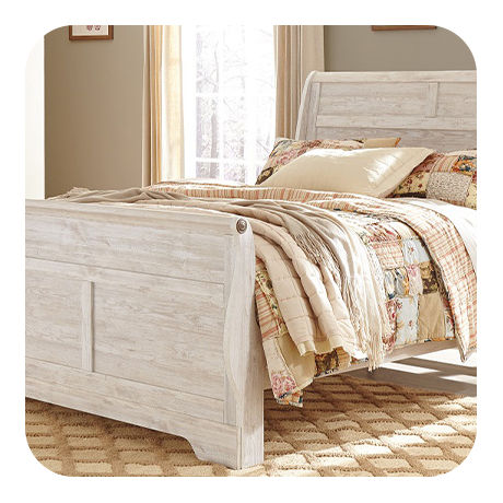 Eloquent Creme Bedding on a Light Wash Stained Wooden Bed Frame.