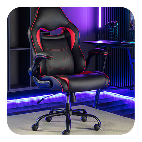 Sleek and Ergonomic Professional Gaming Chair in a RGB-lit Gaming Room with a Gaming PC Setup.