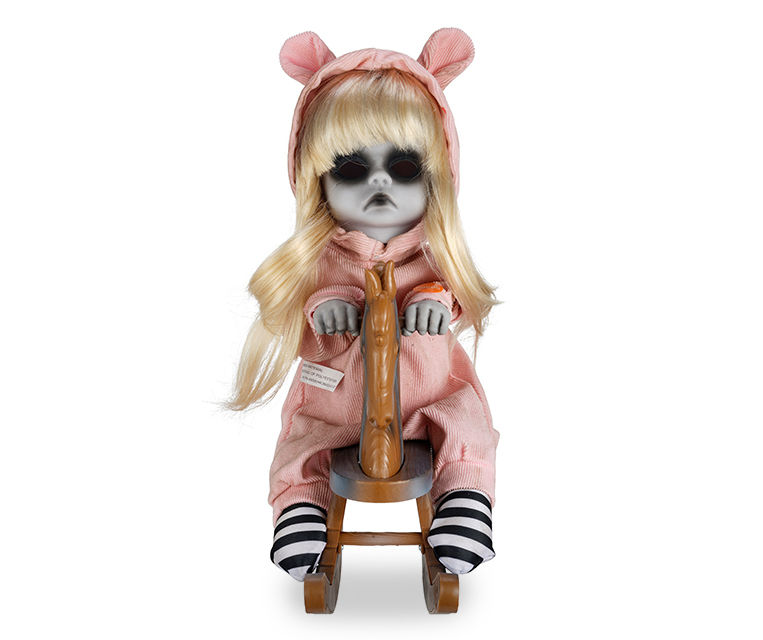 Scary doll on store rocking horse